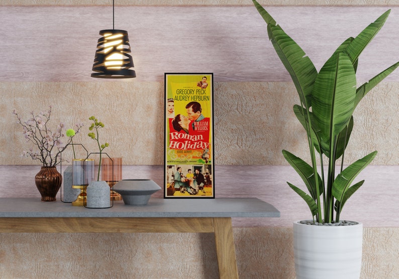 a table with a plant and a movie poster on it