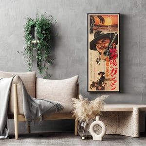 a living room with a gray sofa, a coffee table, and a framed poster of a movie on the wall.