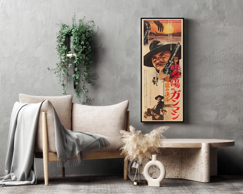 a living room with a gray sofa, a coffee table, and a framed poster of a movie on the wall.