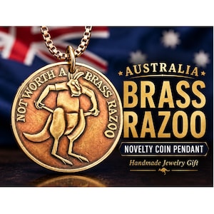 May include: A gold-colored coin pendant with a kangaroo design and the words "NOT WORTH A BRASS RAZOO." The pendant is on a gold chain, with the Australian flag in the background. Text reads "AUSTRALIA BRASS RAZOO NOVELTY COIN PENDANT Handmade Jewelry Gift."