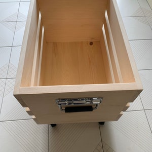 Deluxe Oversized Wooden Crate or Box made of natural wood on castor wheels with spring loaded pull handles with rubber grips.