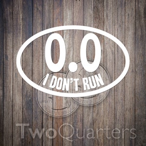 May include: White oval sticker with the text "0.0 I DON'T RUN" in a bold, sans-serif font. The sticker is set against a wooden background. The words "Two Quarters" are at the bottom.