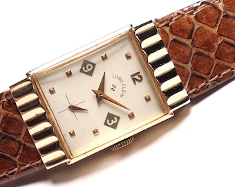 May include: A vintage Lord Elgin wristwatch with a rectangular gold-toned face and a brown leather band. The watch face is cream-colored with gold hands and markers. The band has a snakeskin pattern.
