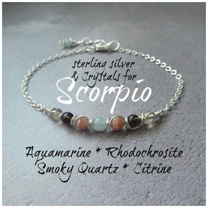 May include: Sterling silver bracelet featuring aquamarine, rhodochrosite, smoky quartz, and citrine gemstones. The bracelet is wrapped with silver wire and has a sterling silver chain. The text "sterling silver & crystals for Scorpio" is written on the image.