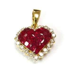 May include: A gold heart-shaped pendant with a red ruby centre surrounded by a halo of small diamonds.