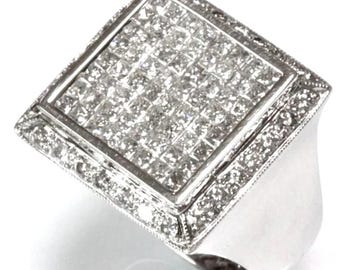May include: A square-shaped ring with a large, pave-set diamond center. The ring is made of white gold and has a polished finish.