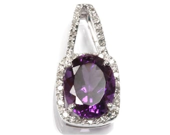May include: A silver pendant with a large oval amethyst gemstone surrounded by a halo of smaller diamonds.