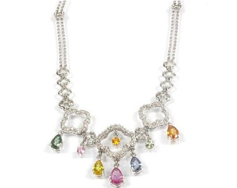 May include: A silver necklace with a delicate chain and a pendant featuring a cluster of small, clear stones. The pendant is adorned with seven dangling pear-shaped gemstones in various colors, including green, pink, yellow, orange, and blue.