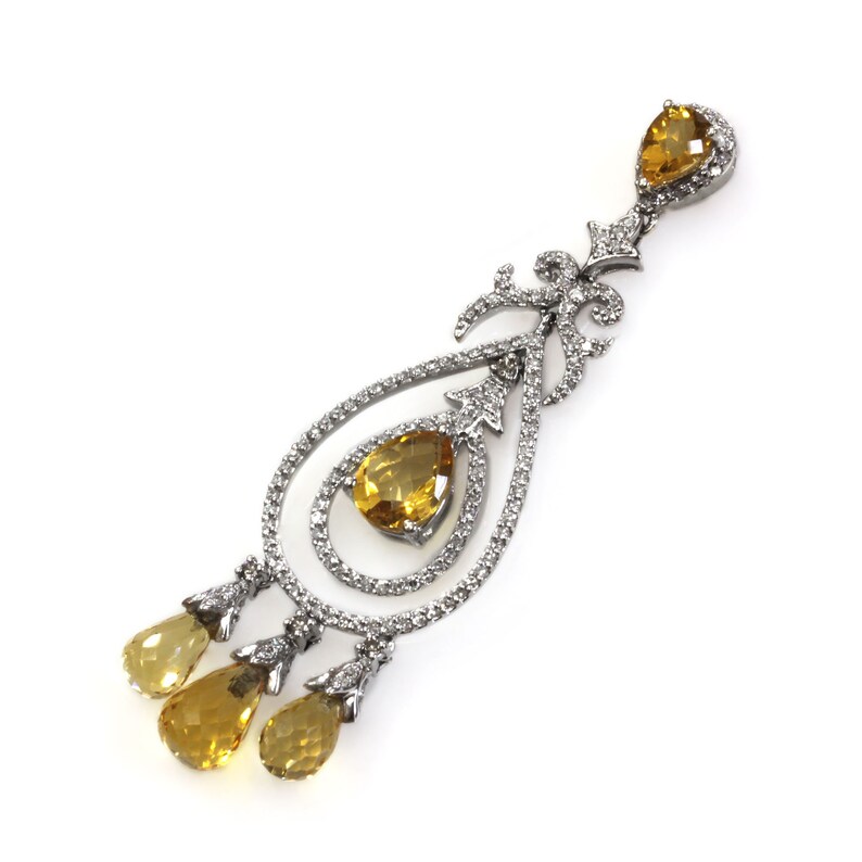 May include: A silver dangle earring with a teardrop-shaped design. The earring features three yellow gemstones and is adorned with small clear stones.