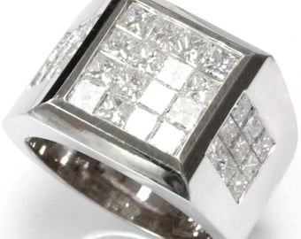 May include: A silver ring with a rectangular face, set with multiple square-cut diamonds. Additional diamonds are set in a diamond-shaped pattern on the sides. The ring has a polished finish and a wide band.