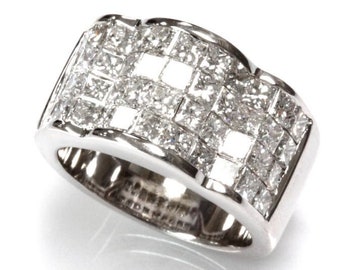 May include: A wide silver band ring with a pave setting of small square-shaped diamonds.