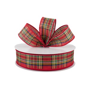 May include: A spool of red and green plaid ribbon with a red edge. The ribbon is tied into a bow on top of the spool.