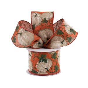 May include: A spool of orange and white patterned ribbon with a pumpkin design. The ribbon is made of a burlap-like material and is perfect for fall crafts and decorations.