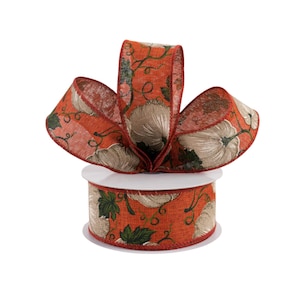 May include: A spool of orange and brown patterned ribbon with a burlap texture and a design of pumpkins and vines.