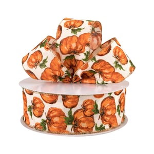 May include: A roll of white fabric ribbon with a gold trim and a pattern of orange pumpkins with green stems.