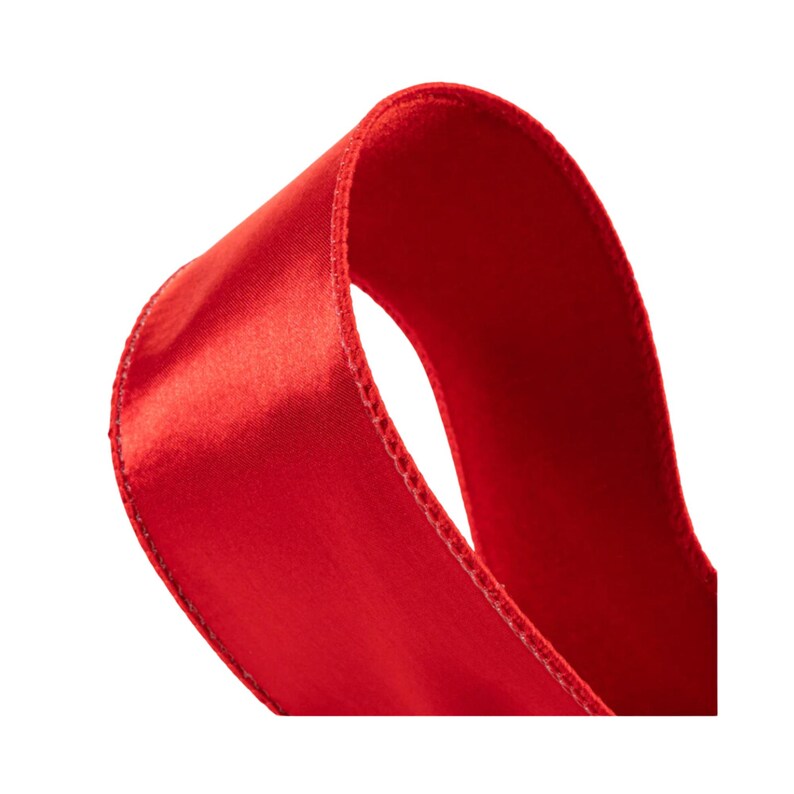 May include: Close-up of a bright red satin ribbon. The ribbon is folded in half, showing the smooth, shiny surface and the edges.