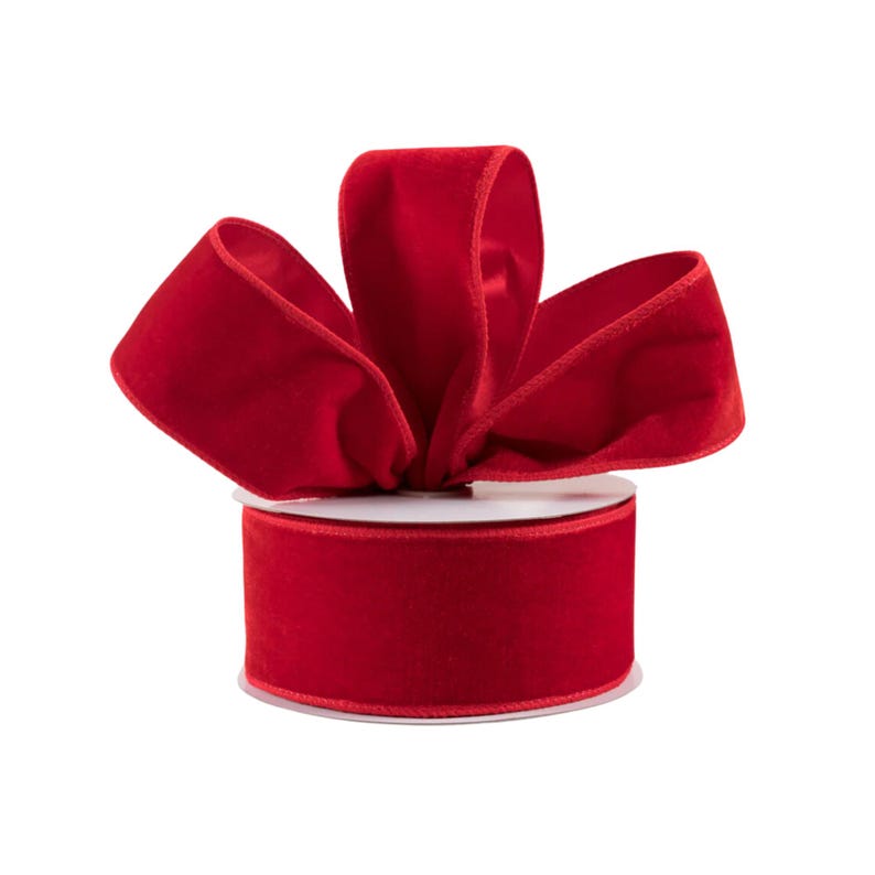 May include: A spool of red velvet ribbon with a bow tied on top. The ribbon is 2.5 inches wide.