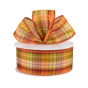 May include: A spool of orange, green, and beige plaid ribbon with a wired edge. The ribbon is 2.5 inches wide and is perfect for crafting and decorating.