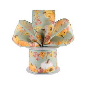 May include: A spool of green ribbon with a fall-themed print of orange, yellow, and white pumpkins and leaves.
