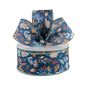 May include: A spool of blue and green ribbon with a fall-themed print of leaves, acorns, and berries. The ribbon is 2.5 inches wide.