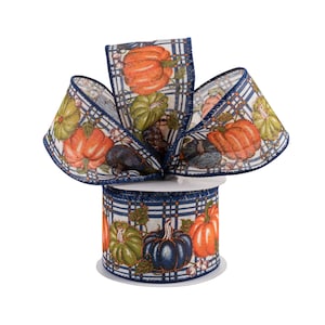May include: A roll of decorative ribbon featuring a fall harvest theme. The ribbon displays a repeating pattern of pumpkins in orange, green, and navy blue, set against a white background with a navy blue plaid design. The ribbon is ideal for autumn crafts.