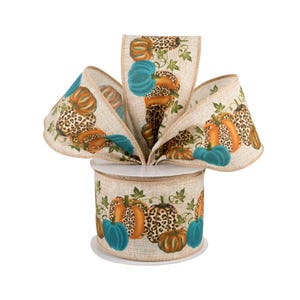 May include: A roll of beige burlap ribbon featuring a repeating pattern of pumpkins in orange, teal, and leopard print, accented with green vines. The ribbon is arranged in a decorative bow shape, showcasing the textured fabric and colorful print.