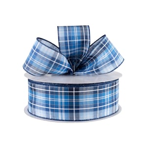 May include: A roll of blue and white plaid ribbon with a bow tied on top. The ribbon is on a white spool.