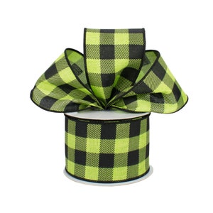 May include: A roll of black and lime green buffalo plaid ribbon. The ribbon is on a spool and is ready to be used for crafting or decorating.