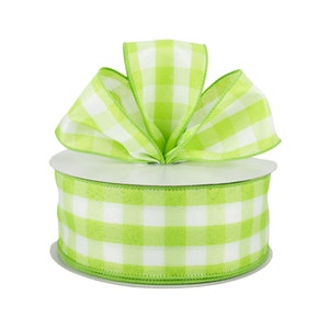 May include: A spool of lime green and white checkered ribbon with a large bow on top. The ribbon is made of a woven material and is perfect for crafting, gift wrapping, or decorating. The bow adds a decorative touch.