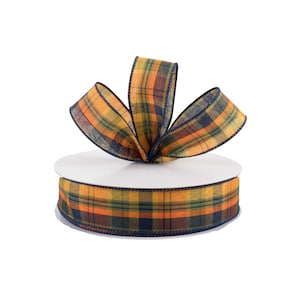 May include: A spool of orange, yellow, green, and blue plaid ribbon with a bow tied on top.
