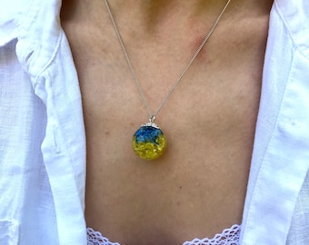 Ukraine flag necklace with real blue and yellow pressed flowers in resin.