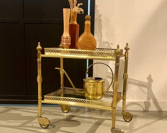 Small neoclassical French bar cart made of brass.