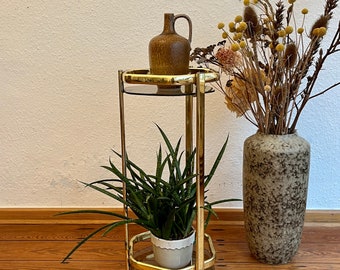 70s golden flower stool with two glass trays.