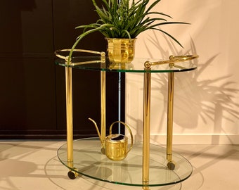 Golden 70s serving trolley with glass trays.