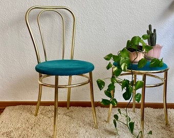 Golden chair with a turquoise fabric cushion.