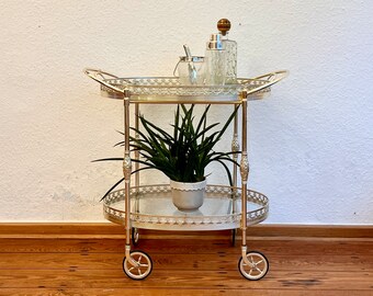 Oval neoclassical bar cart with removable glass tray.