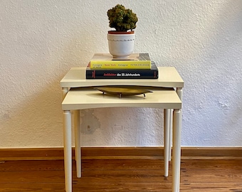 Two nesting tables made of wood.
