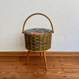 Beautiful mid century 50s/60s sewing basket made of rattan weave on wooden legs.