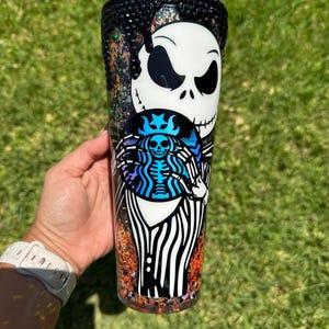 Pumpkin King holding Starbucks siren glow in the dark Snowglobe Tumbler with bling lid and drip