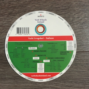 May include: A colorful wheel chart with the title "Verbi Irregolari - Italiano" and the words "Verb Wheels Ireland" at the top. The chart shows the conjugation of irregular verbs in Italian, including the infinitive, present, past, future, and conditional tenses.