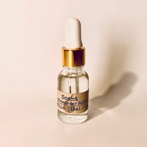 May include: A clear glass bottle with a gold cap and a white dropper. The bottle is labeled "Scent Diffuser Refills 15ml / 0.5oz".