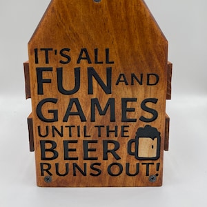 May include: Wooden beer bottle holder with the text "It's all fun and games until the beer runs out!" and a beer mug graphic.