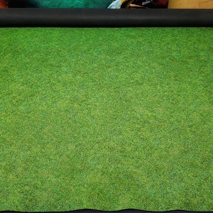 May include: A green felt gaming mat with a textured surface, ideal for tabletop games and role-playing.