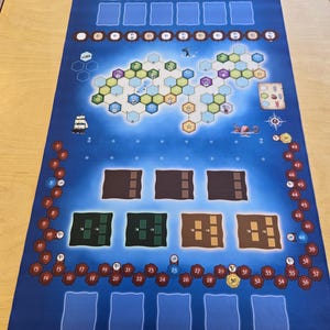 May include: A blue game board with a hexagonal island in the center. The island has various colored spaces and numbers. There are also spaces for cards and tokens around the perimeter of the board.
