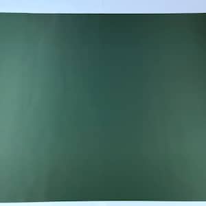May include: A solid, dark green rectangular sheet of paper. The paper is a matte finish and appears to be a single, uniform color. The sheet is lying flat on a white surface.