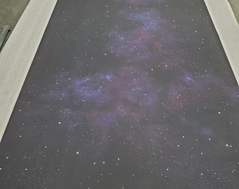May include: A dark gray canvas with a printed image of a galaxy with a white, blue, and pink nebula. The galaxy is filled with white stars.