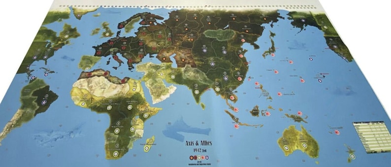 May include: A world map game board for Axis & Allies 1942, featuring a blue ocean, green landmasses, and red and white markers. The board shows the continents of Europe, Asia, Africa, and Australia.