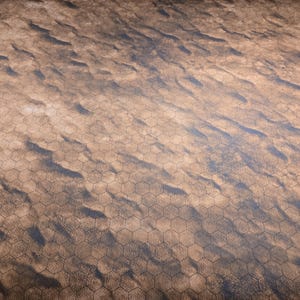 May include: A brown and tan gaming mat with a hexagonal grid pattern. The mat has a desert-like appearance with dark, wavy patterns. A blue ruler is visible along the top edge.