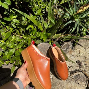 Leren instaplaarzen | Schapenvachtklompen | Bontlaarzen | Outdoorpantoffels | Tazz-pantoffels