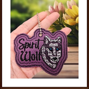 May include: Purple embroidered keychain with the words "Spirit Wolf" and a wolf's face with blue eyes.